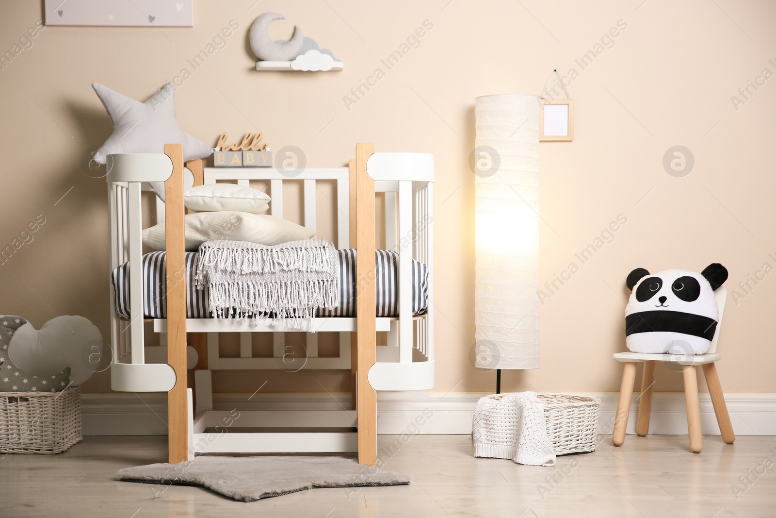 Photo of Cute baby room interior with modern crib and toys