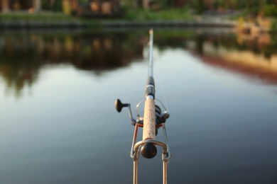 Photo of Fishing rod at lake on sunny day