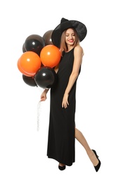 Beautiful woman wearing witch costume with balloons for Halloween party on white background