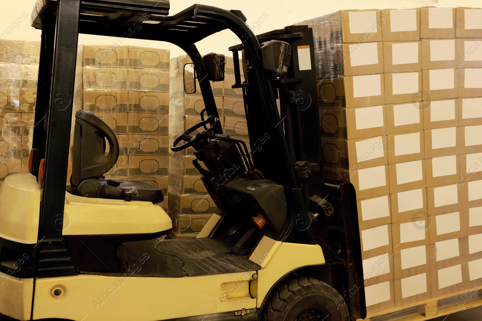 Image of Forklift truck with boxes in warehouse. Logistics concept