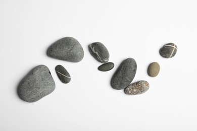 Many different stones on white background, top view