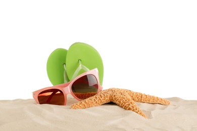 Photo of Beach accessories on sand against white background