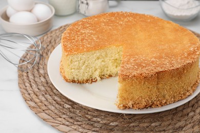 Photo of Tasty sponge cake on white table, closeup