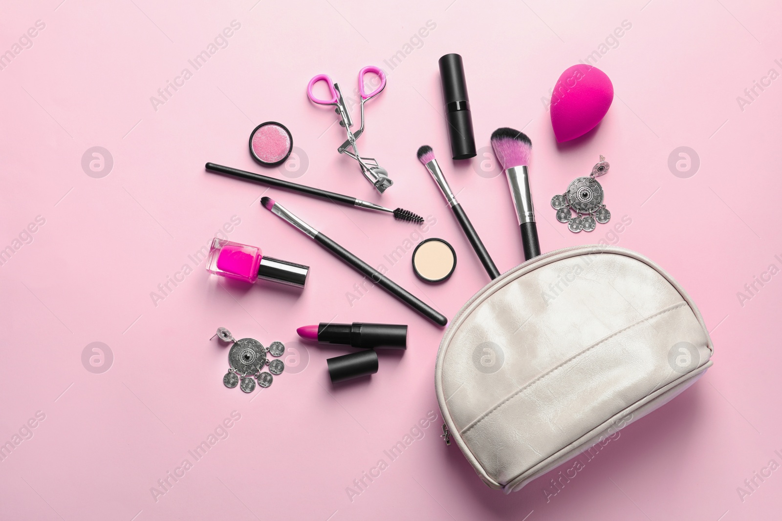 Photo of Makeup products with cosmetic bag on color background