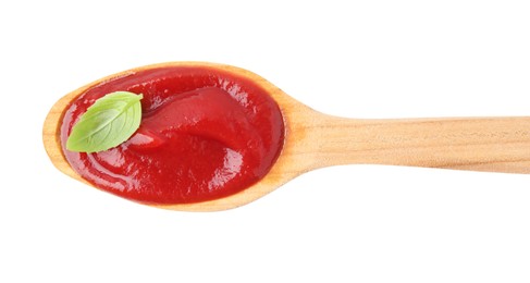 Wooden spoon with tasty ketchup and basil isolated on white, top view