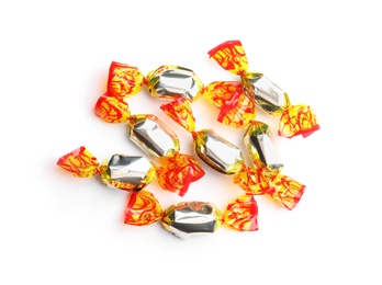 Photo of Delicious candies wrapped in foil on white background, top view