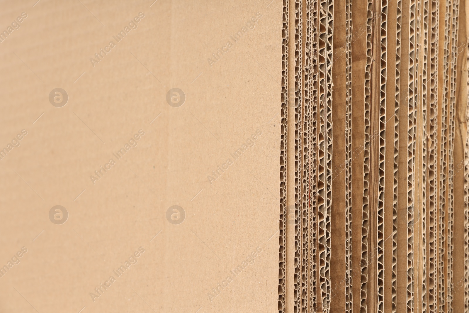 Photo of Sheets of brown corrugated cardboard as background, closeup