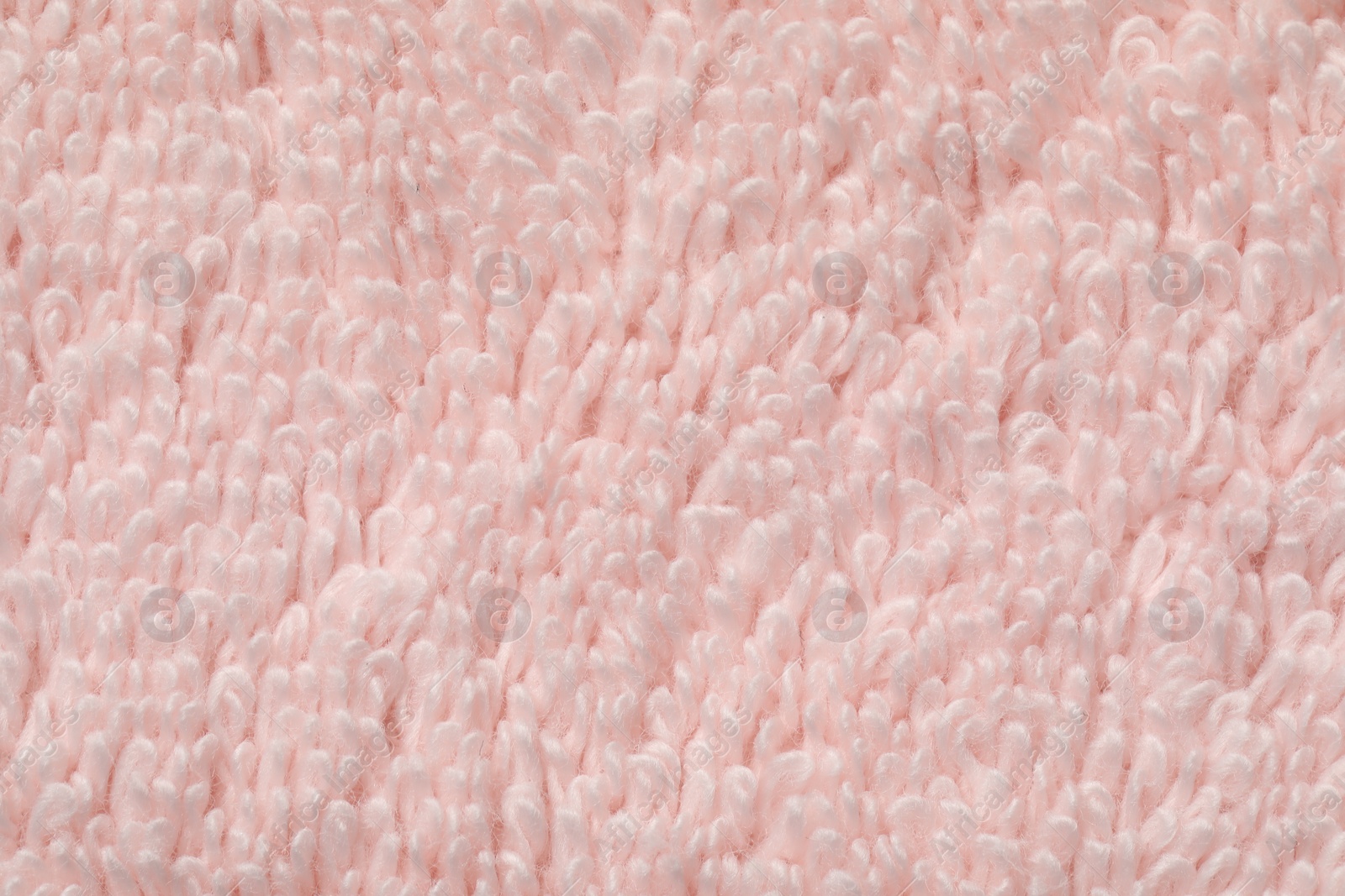 Photo of Texture of soft light pink fabric as background, top view