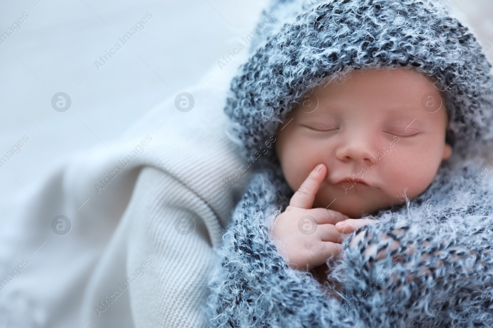 Photo of Cute newborn baby sleeping on plaid, top view