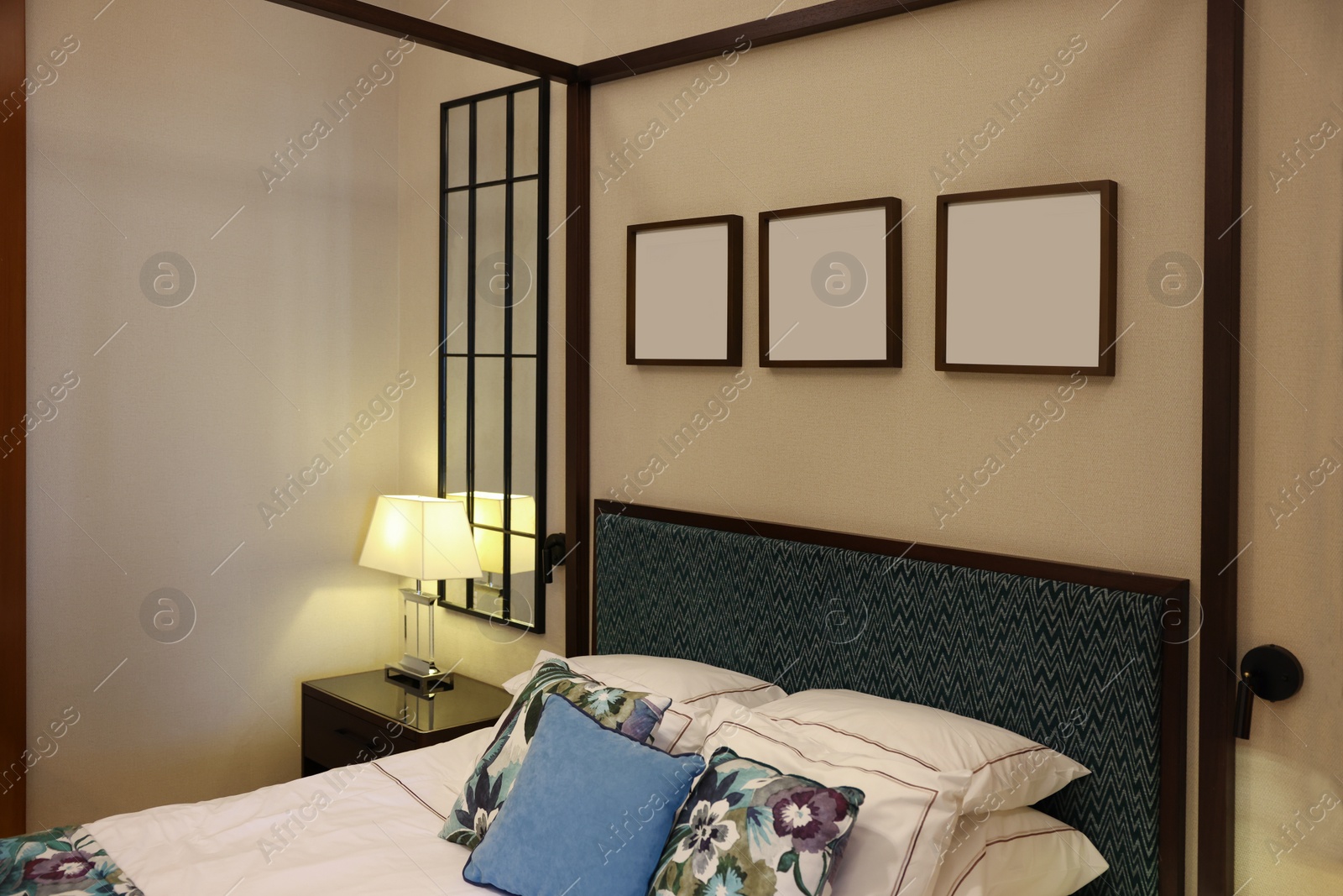 Photo of Large bed with pillows and linens in comfortable hotel room