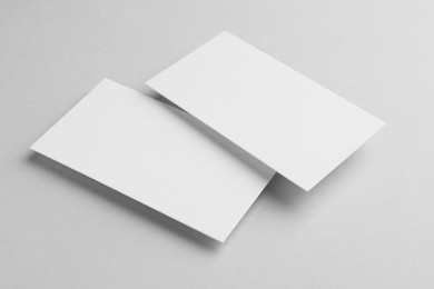 Blank business cards on light grey background. Mockup for design