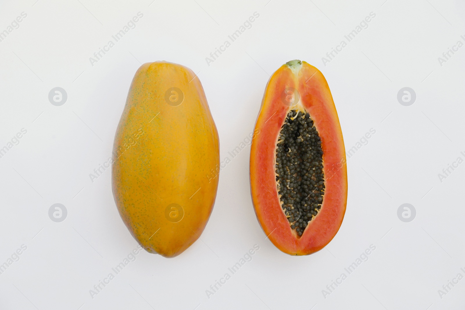 Photo of Fresh ripe papaya fruits on white background, flat lay