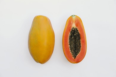 Fresh ripe papaya fruits on white background, flat lay