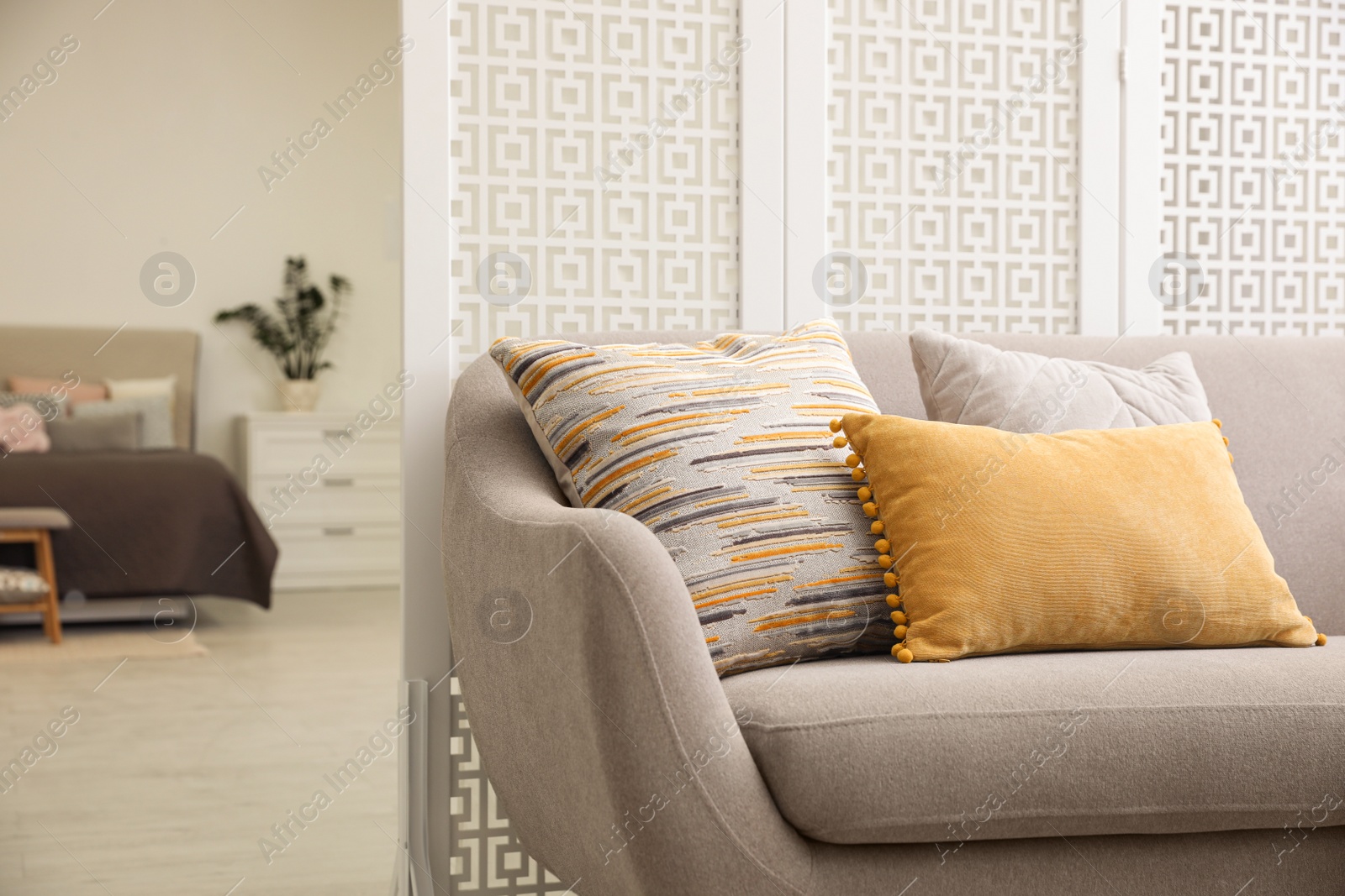 Photo of Comfortable sofa with different pillows in stylish room interior