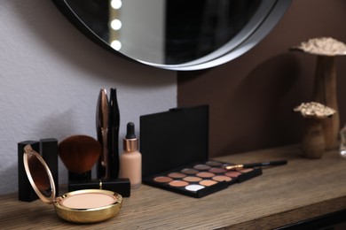 Photo of Different decorative cosmetic products on dressing table