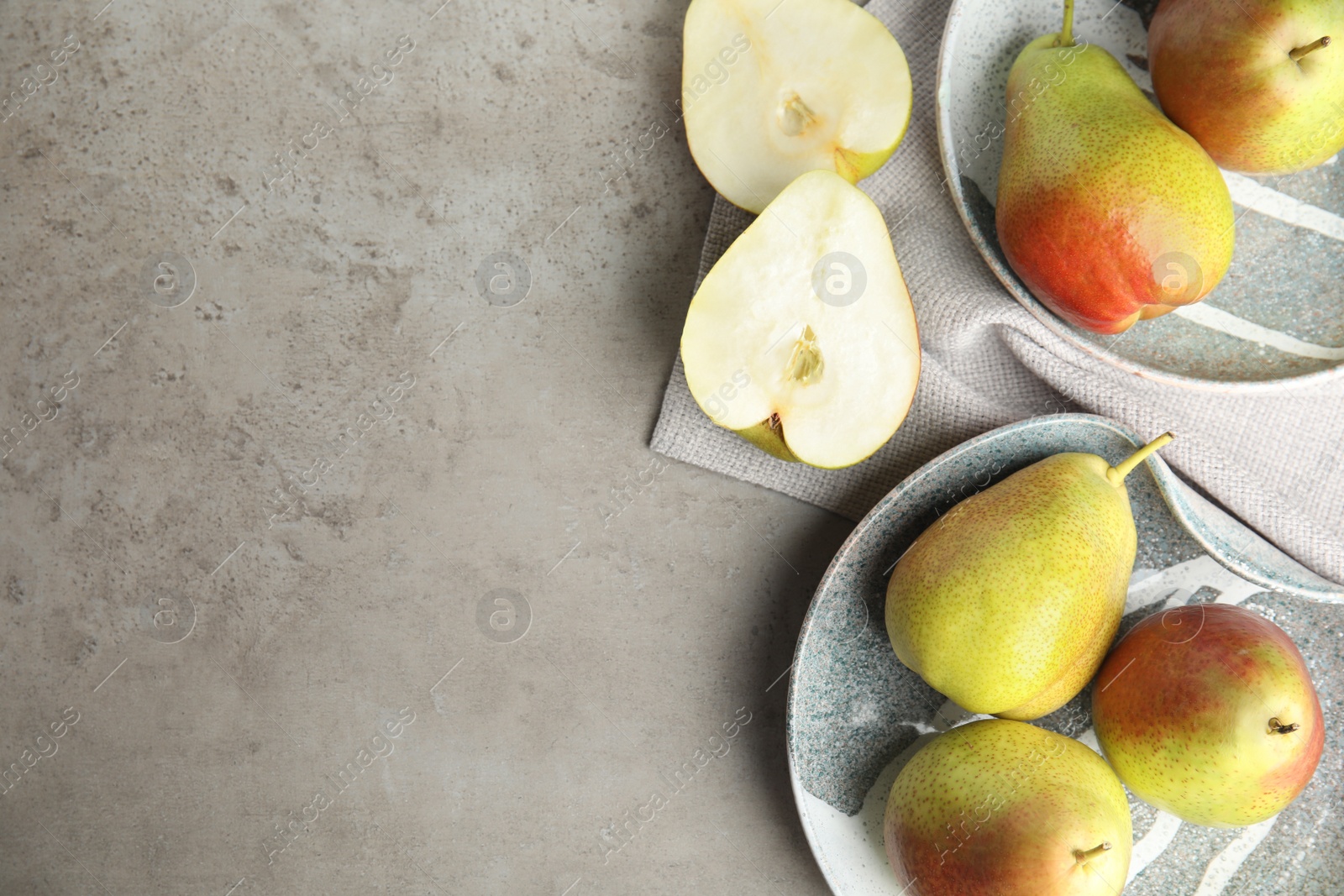 Photo of Composition with ripe juicy pears on grey stone table, flat lay. Space for text