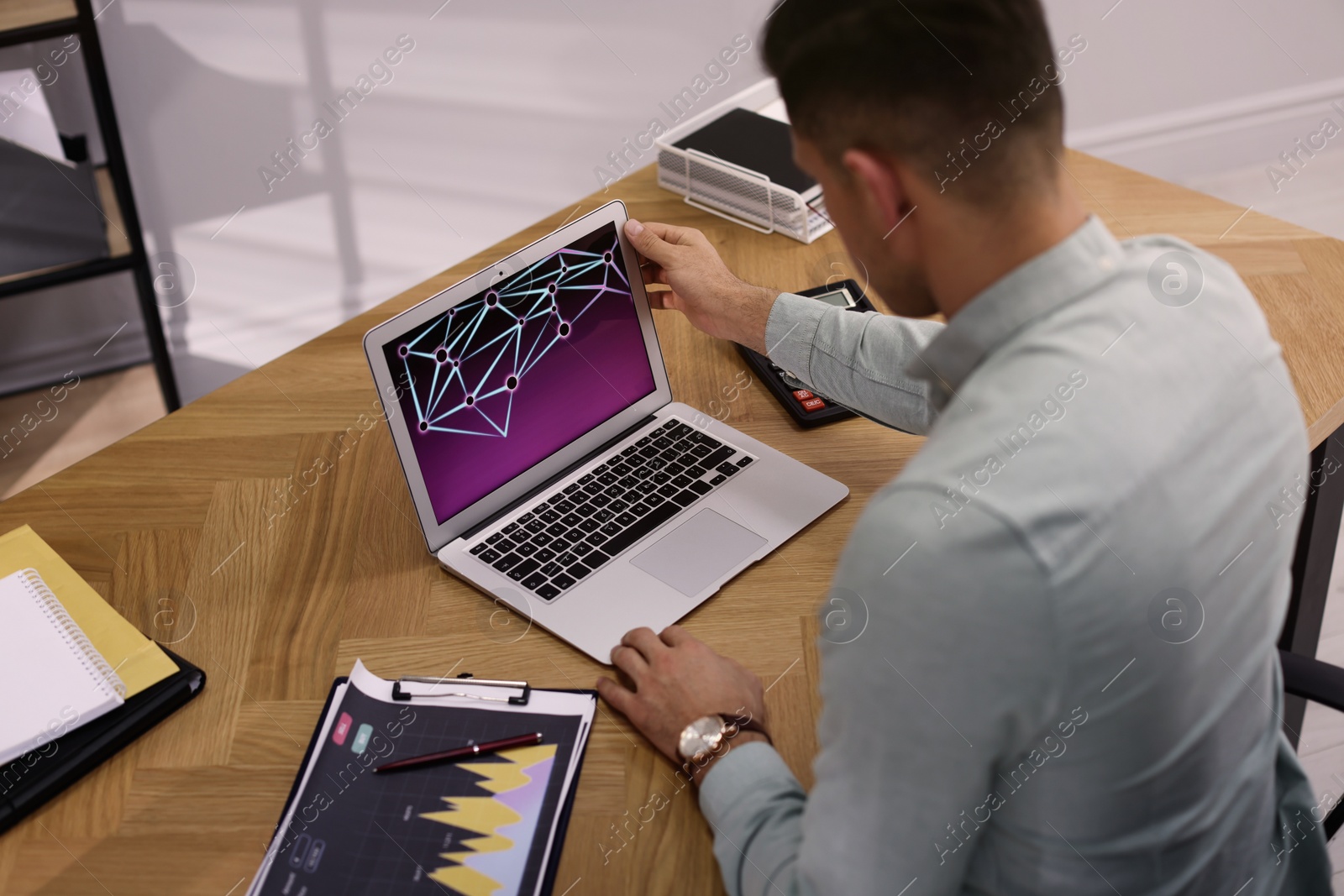 Photo of Businessman working with laptop in office, above view. Forex trading