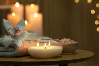 Photo of Composition with different spa products and orchid flower on wooden table