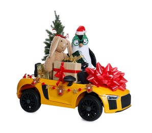 Photo of Child's electric car with toys, gift boxes and Christmas decor on white background