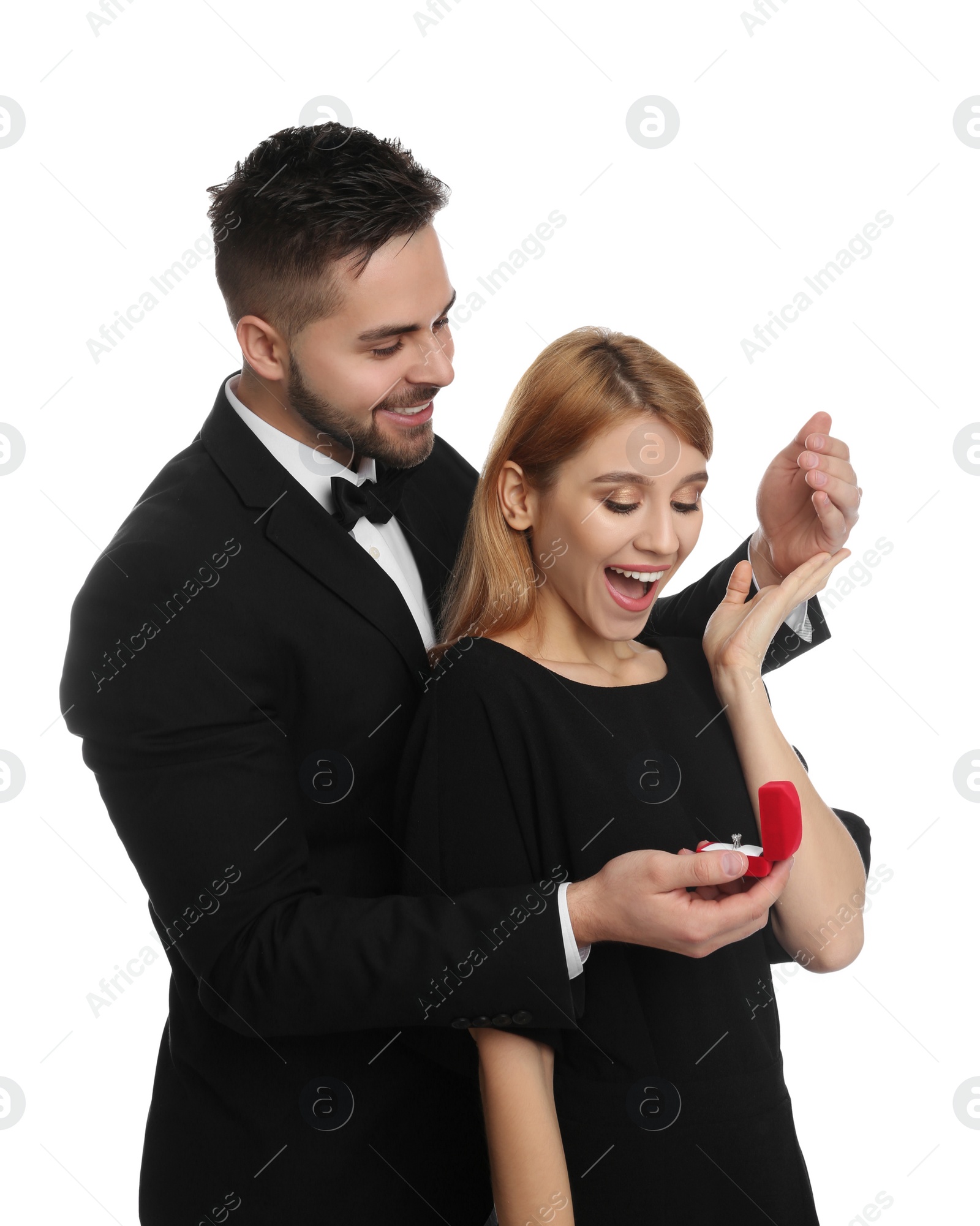 Photo of Man with engagement ring making marriage proposal to girlfriend on white background