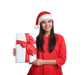 Photo of Happy young woman in Santa hat holding Christmas gift on white background