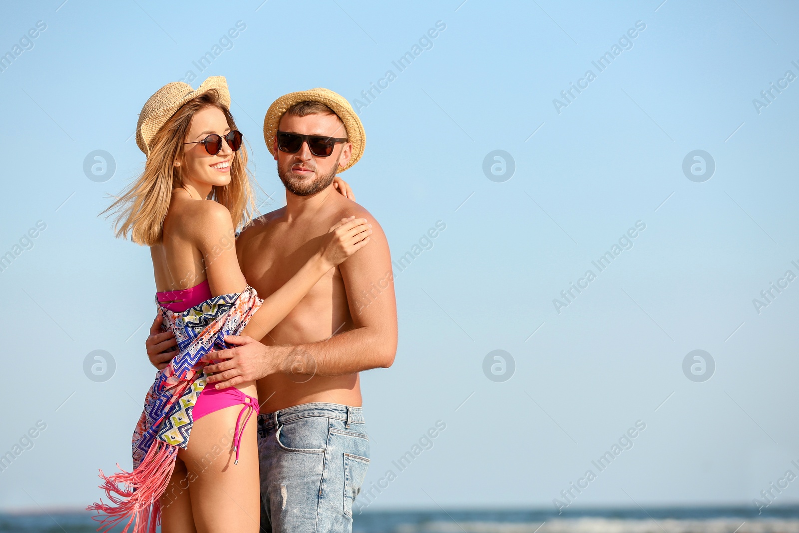 Photo of Young couple spending time together on beach