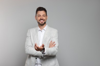 Photo of Happy teacher in light suit against beige background