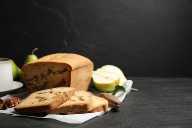 Photo of Composition with tasty pear bread on black slate table, space for text. Homemade cake