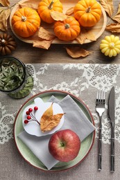 Photo of Happy Thanksgiving day. Beautiful table setting, pumpkin shaped card and autumn decoration on wooden background, flat lay