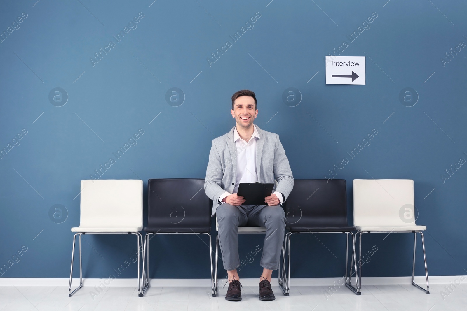 Photo of Young man waiting for job interview, indoors