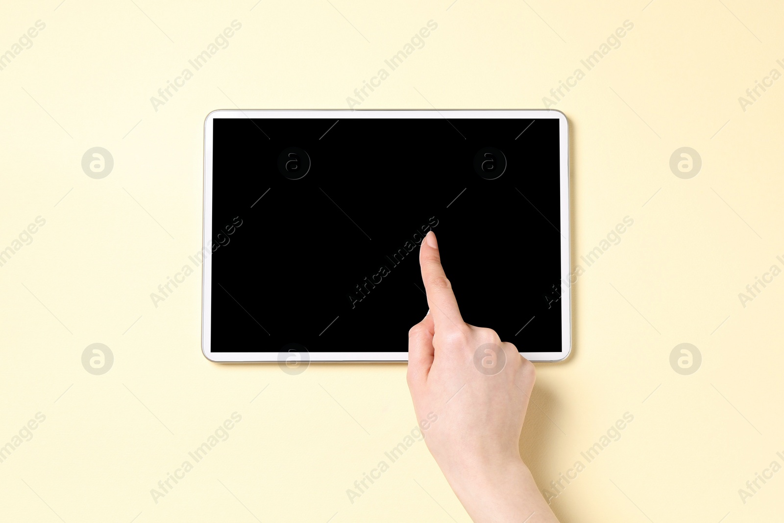 Photo of Online store. Woman using tablet on beige background, top view