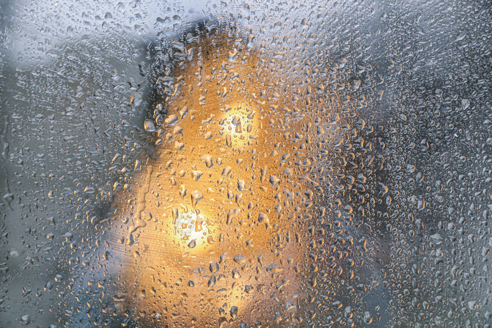 Photo of Closeup view of foggy window with rain drops