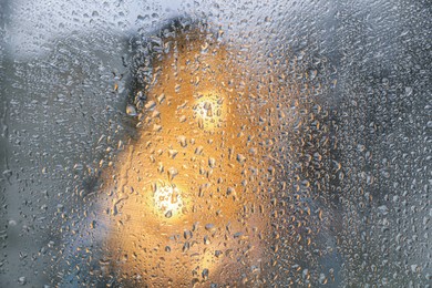 Closeup view of foggy window with rain drops