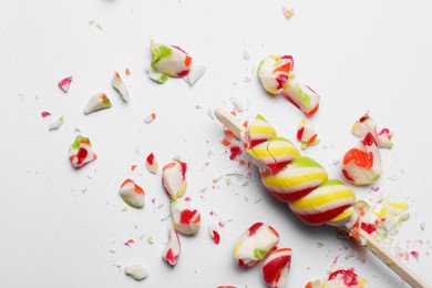 Smashed sweet lollipop on light background, top view