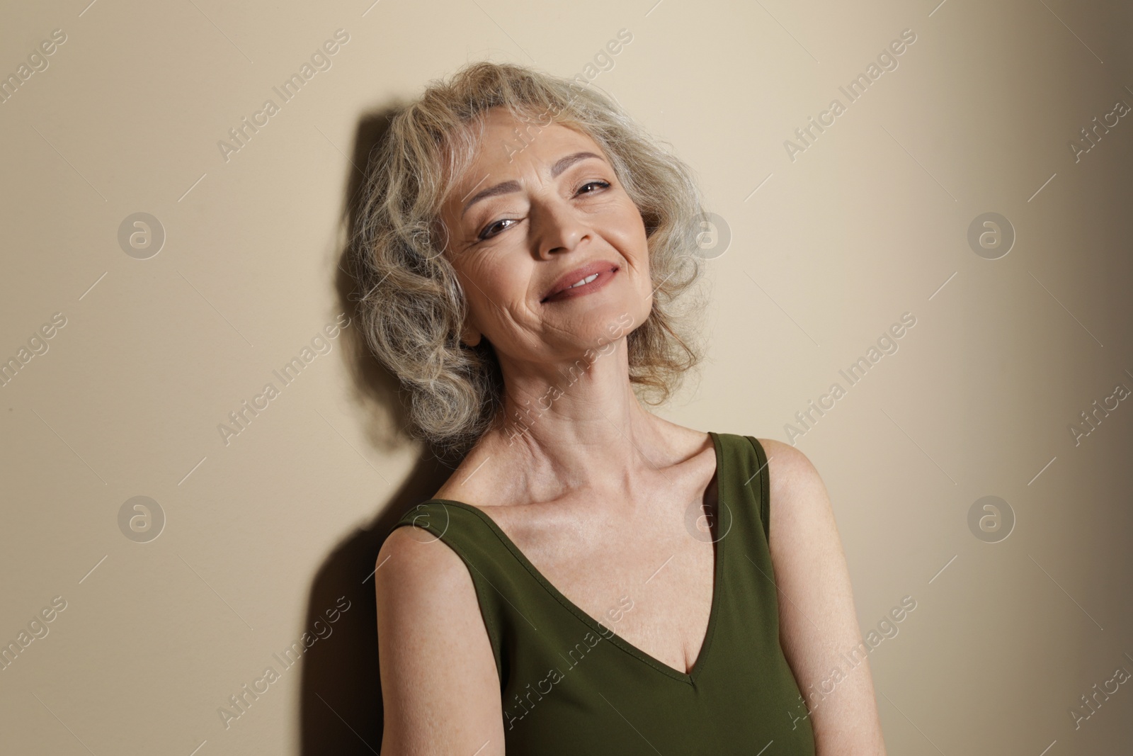 Photo of Portrait of mature woman on color background