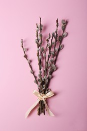 Photo of Beautiful blooming willow branches on pink background, top view