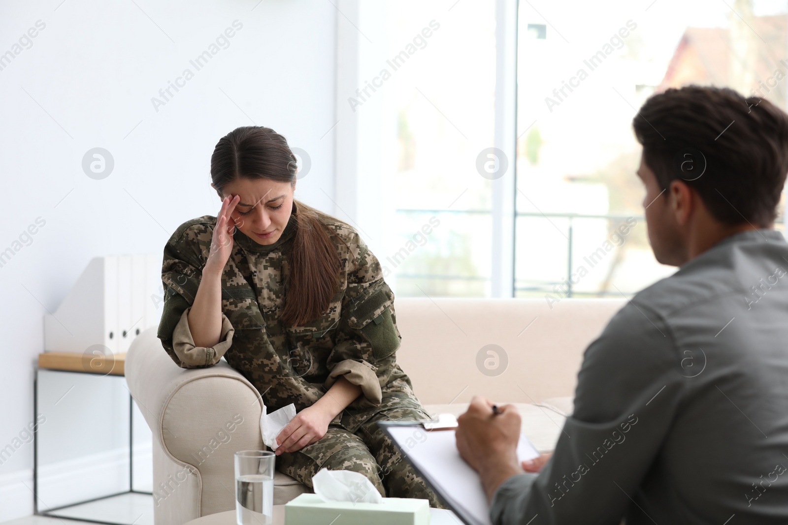 Photo of Psychotherapist working with female military officer in office