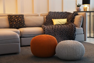 Living room interior with different stylish knitted poufs and sofa