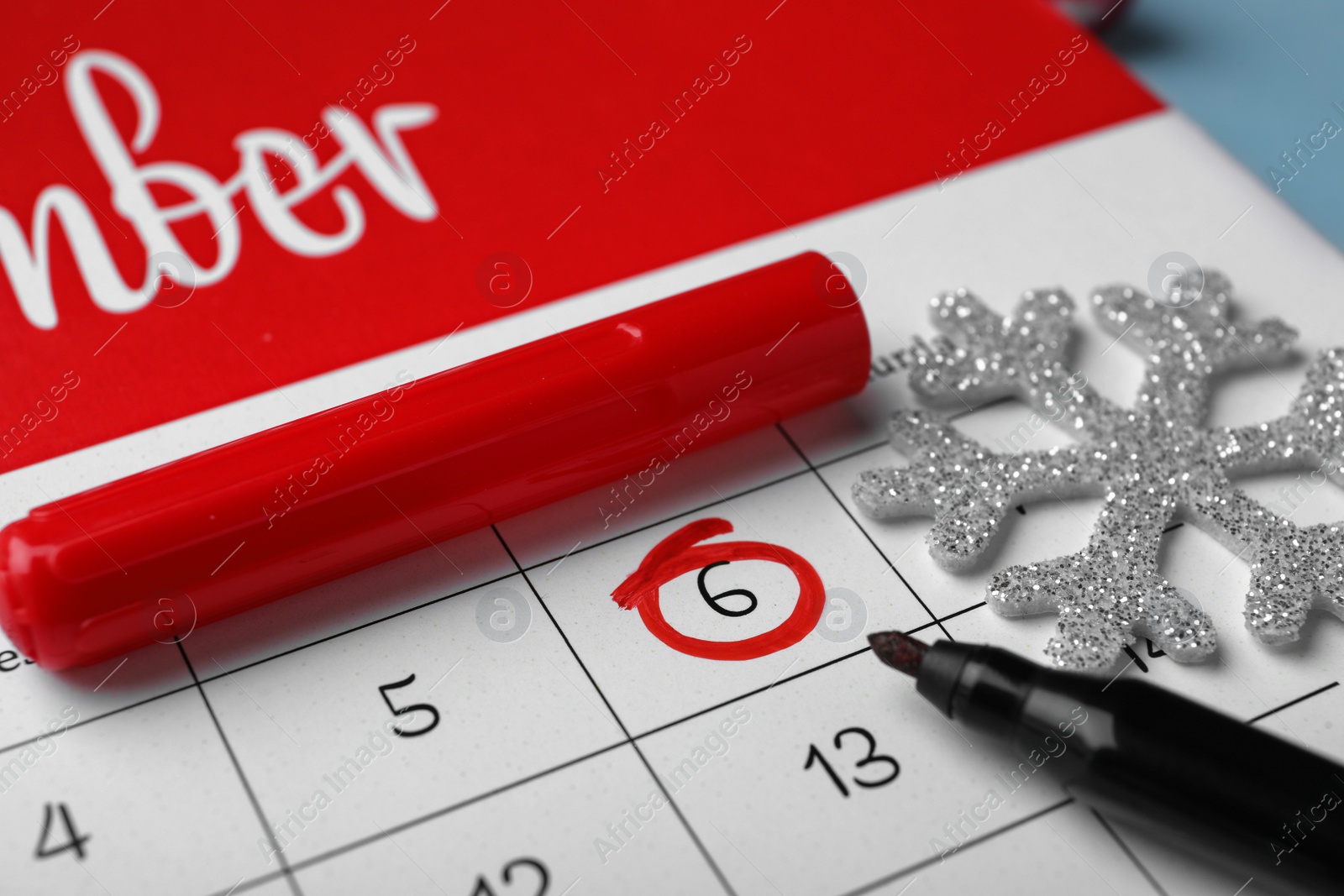 Photo of Saint Nicholas Day. Calendar with marked date December 6, marker and snowflake, closeup