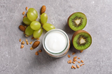 Jar with yogurt, granola and fruits on table, top view