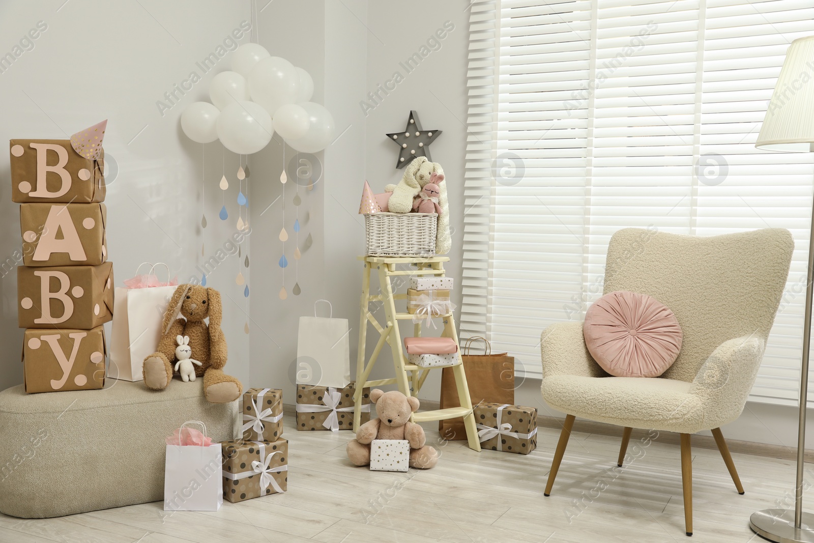 Photo of Baby shower party. Festive decor, gift boxes and toys in stylish room