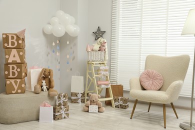 Baby shower party. Festive decor, gift boxes and toys in stylish room