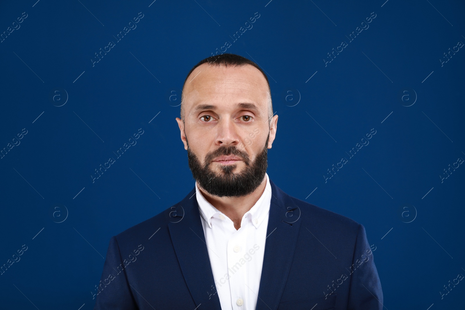 Photo of Portrait of handsome man on blue background