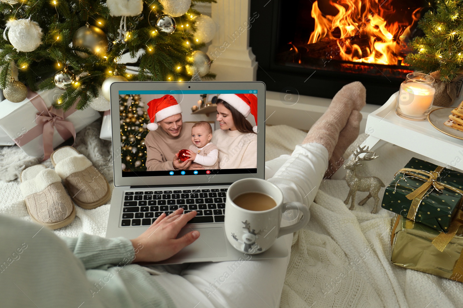 Image of Young woman having online meeting with family members via videocall application at home, closeup