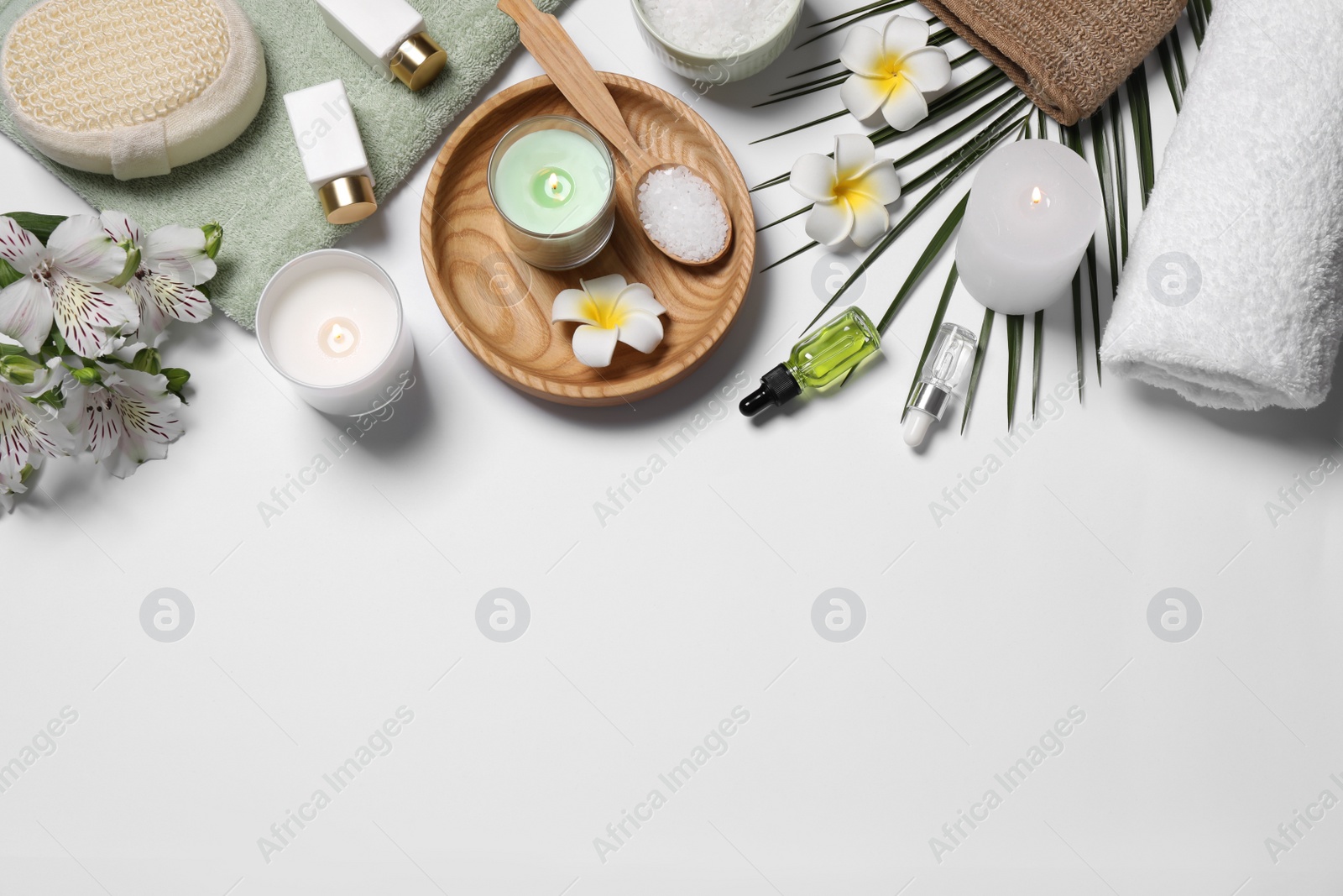 Photo of Flat lay composition with spa essentials on white background. Space for text