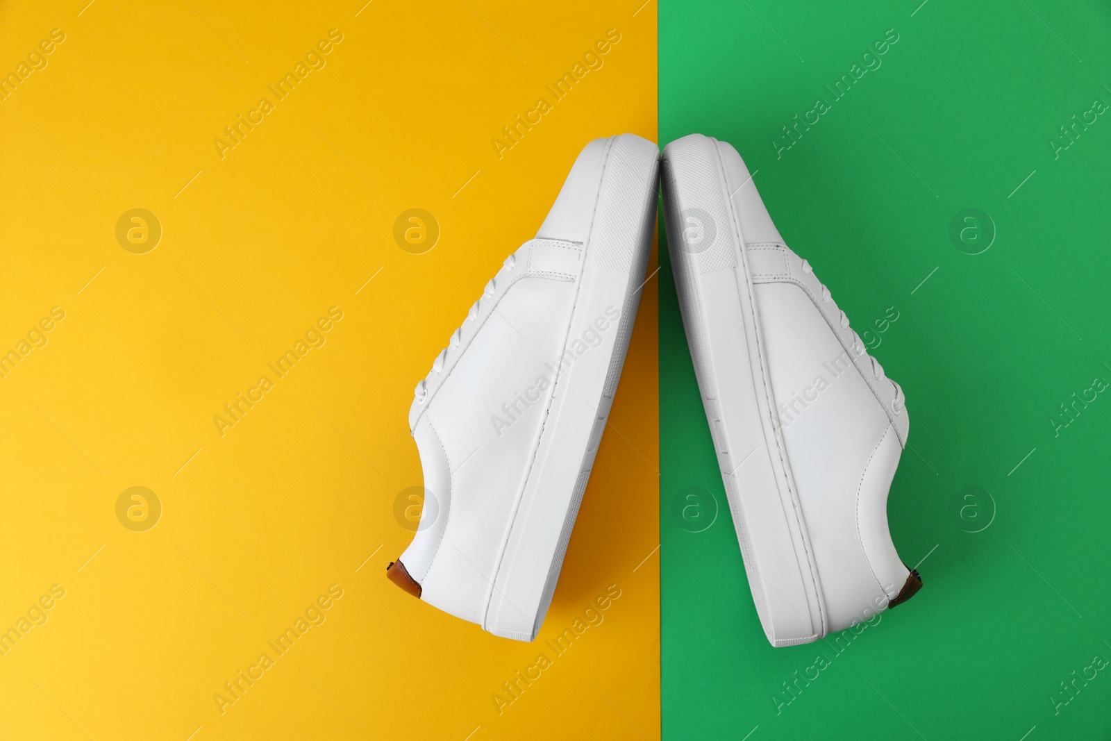 Photo of Pair of stylish sports shoes on color background, flat lay. Space for text