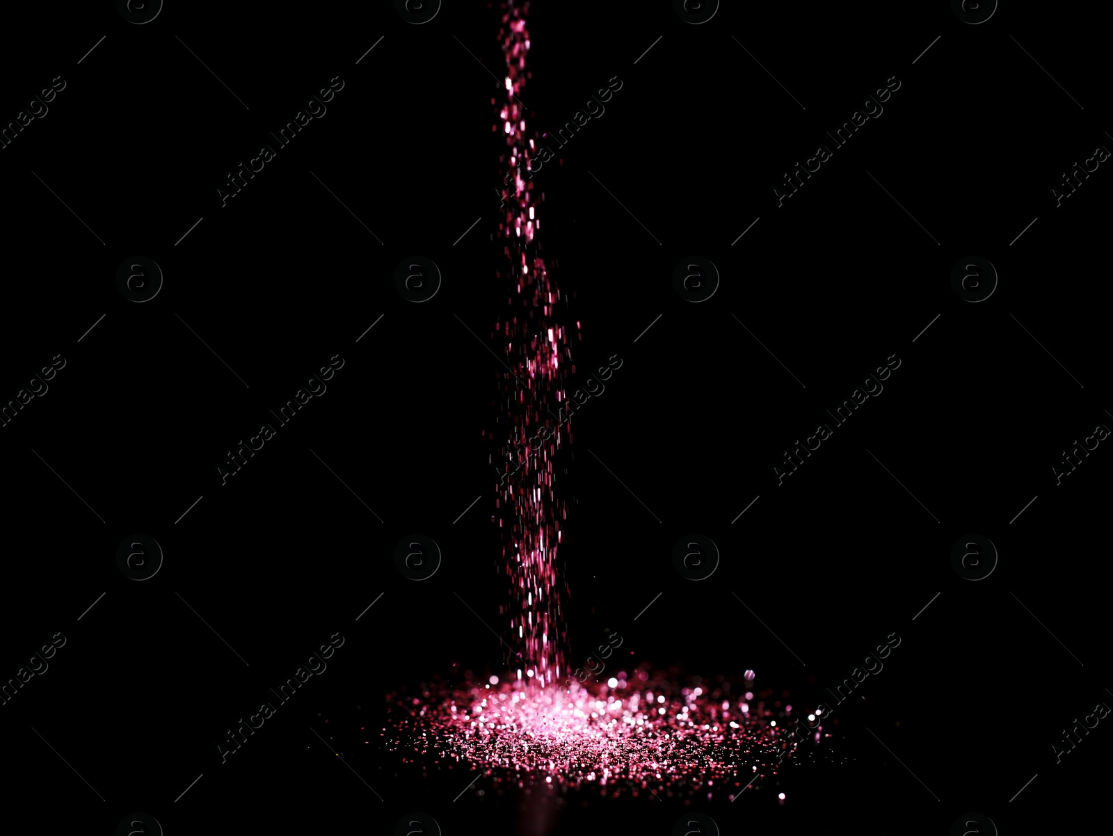 Photo of Sprinkling rose glitter on black background, bokeh effect