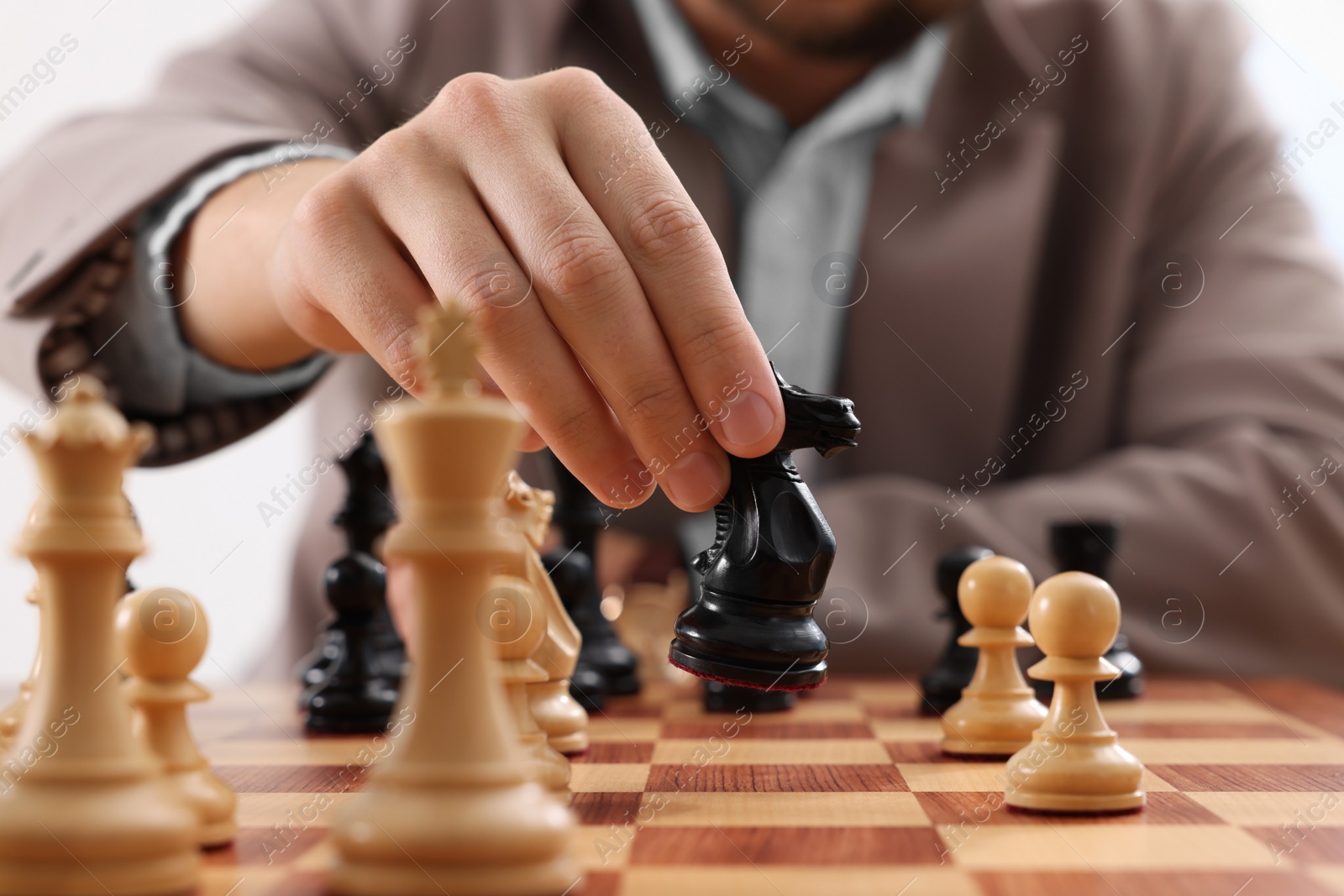 Photo of Man playing chess during tournament at chessboard, closeup