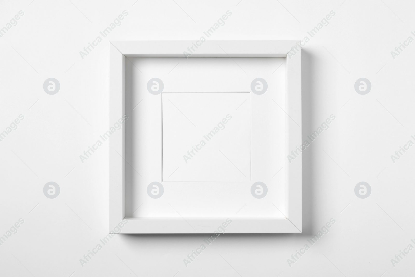 Photo of Empty frame on white background. Mockup for design