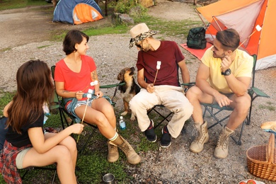 Photo of People having lunch near camping tent outdoors